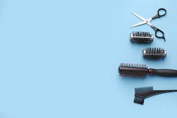 Set of hairdresser's accessories on color background