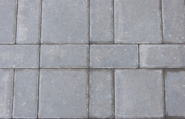 Obraz premium Gray texture of paving stones. Close-up of stone tiles for sidewalks