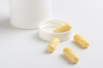 pills and bottle on white background