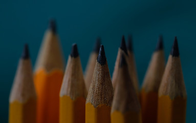 Sharpened wooden yellow pencils grouped together with one in focus the others a little out of focus