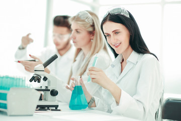 group of young scientists conduct research in the laboratory .