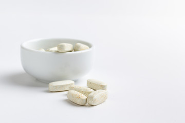 Fototapeta na wymiar pills in a bowl isolated on a white background