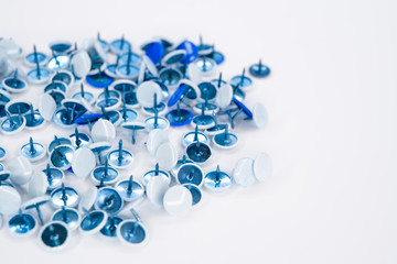 blue thumbtacks on white background