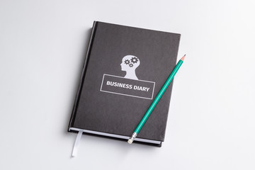 business diary and pencil on white background isolated