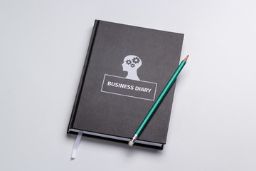 business diary and pencil on white background isolated