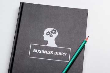 business diary and pencil on white background isolated