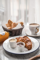 French breakfast table with croissant and coffee