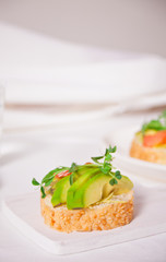 sliced avocado on toast bread with herbs.