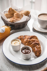 French breakfast table with croissant and coffee
