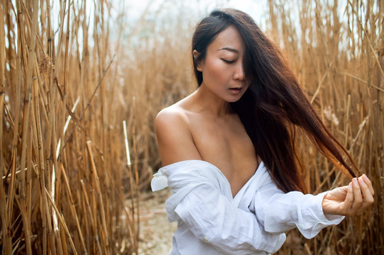 Sexual beautiful Woman Posing In The Thicket Of Reeds.
