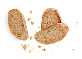 Freshly baked bread isolated on a white background. Crumbs and Bread slice close up. Top view.