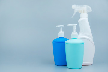 A set of cleaning and disinfection products on a gray background. Close-up with space for text. Prevention of coronavirus