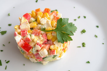 salad tower of crab sticks  with sweet corn, cucumber, bell pepper, and egg dressed with mayonnaise