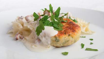 turkey meatball with farfalle under sour cream chanterelles  sauce sprinkled with parsley