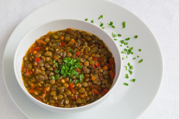 a bowl of red lentil stew decorated with parsley