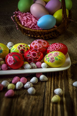 Easter composition on a wooden background. Hand painting Easter eggs. The concept of religious holidays, family traditions. Selective focus.