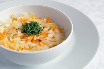 a bowl of raw vegetable salad decorated with dill 