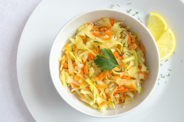 cabbage carrot and dill salad dressed with oil and decorated with parsley leaf