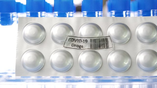 27949_A_round_drug_Covid-19_Droge_written_in_German_pack_of_medicine_for_coronavirus.mov