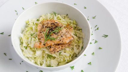 salad of white cabbage with fried chicken breast and dill