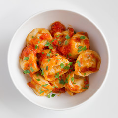 ravioli with tomato sauce decorated with parsley 