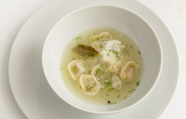 dumplings in broth with dill and sour cream