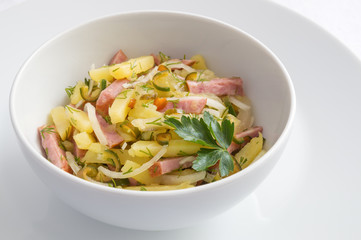 vegetable salad with sausage decorated with parsley leaf