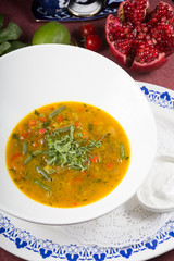 Yellow curry soup in a white bowl