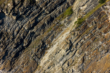 The close-up relief of the rocks. Rock pattern texture lines background