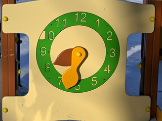 painted children's wooden clock in a city park