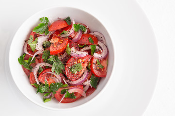 a bowl of tomato salad with red onion