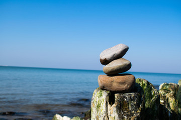 zen stones by the sea or ocean on a sunny day