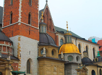 Fototapeta na wymiar The Wawel Castle, royal castle on Wawel Hill, Domes of two Renaissance chapels in Krakow, Poland.