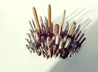 The iron city of screws and bolts casts a shadow in creative and abstract macro photography