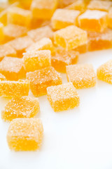 Pineapple, lemon, vanilla pate de fruit (jelly, marmalade, fruit candy) covered with sugar. White background, back view. 