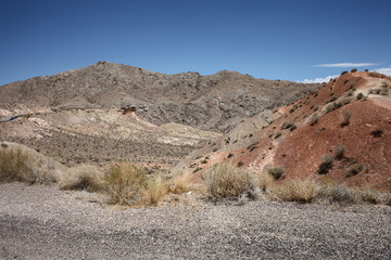 Grey mountain range leading into red rock in the Eldorado Canyon, Nevada, USA