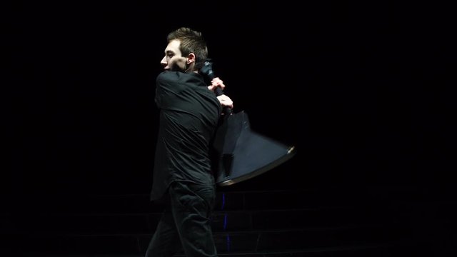 Musician making guitar flips on stage
