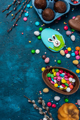 Fototapeta na wymiar Colorful Easter Festive Background. Sweet Food Candy and Chocolate Eggs and Rabbit