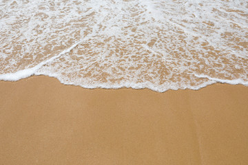 Fototapeta na wymiar Sand beach and wave, top view