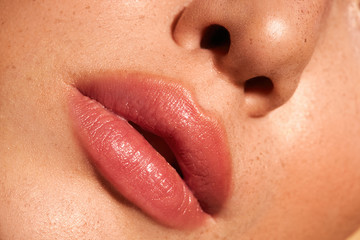 Close-up nude lips. Fresh make-up. Clean skin. Natural retouching 