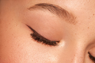 Close up of female clouse eye. Clean skin. Blue eyes.Natural retouching. Arrows on the eyes 