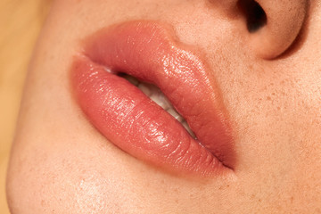 Close-up nude lips. Fresh make-up. Clean skin. Natural retouching