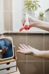 Closeup of a woman's hands applying hydrating cream to soften the skin. Nourishing skincare at home.
