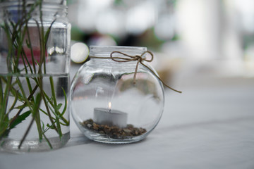 Tea light in a decorative glass in the summertime. Bright wedding decor concept.