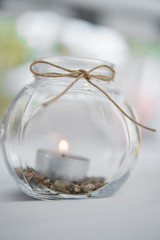 Tea light in a decorative glass in the summertime. Bright wedding decor concept.