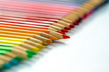 Colorful pencils on white background - closeup with selective focus