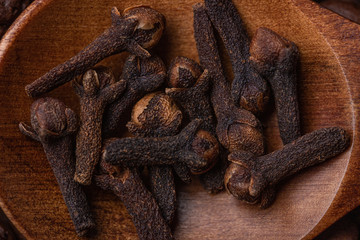 Clove in a wooden spoon close-up