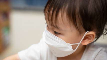 Virus mask Asian boy wearing face protection in prevention for virus in  supermarket,Thailand. COVID-19, Coronavirus, epidemic virus symptoms and Air pollution pm2.5 concept.