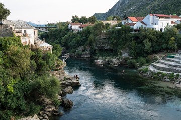 Fototapeta na wymiar View of the Neretva River and the embankment in Mostar Bosnia and Herzegovina