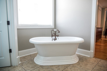 Naklejka na ściany i meble Pure white retro old fashioned vintage new bathtub tub in a new construction bathroom with natural light